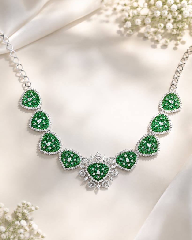 Floating emerald and diamond station necklace with cluster motifs
