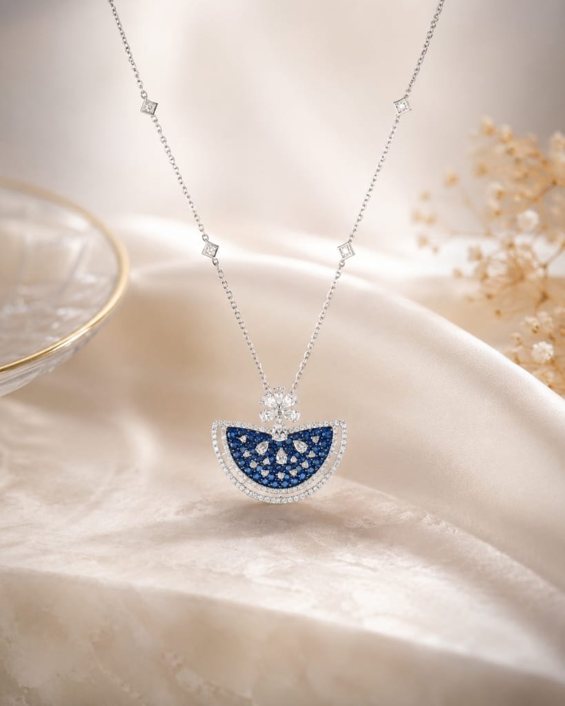 Floating crescent blue sapphire pendant with floral diamond accent