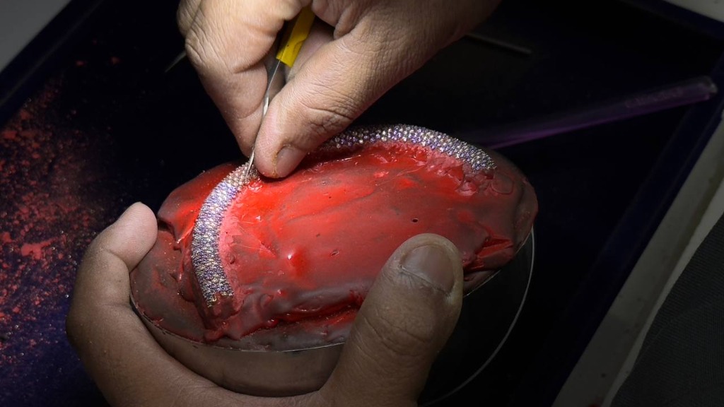 Master diamond setter setting diamonds with micro-precision tools
